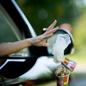 JESUS OBSERVED THE LAW SO WE DON'T HAVE TO::YOUNG WOMAN THROWS WASTE FROM THE CAR © Slava Dumchev | Shutterstock.com