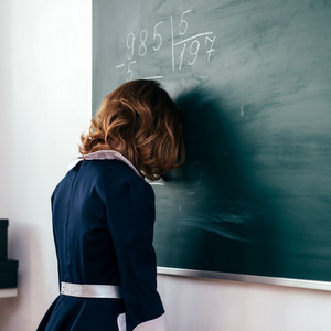 153= I AM G-D?::GIRL WITH HER FOREHEAD ON THE CHALKBOARD © Undrey | Dreamstime.com