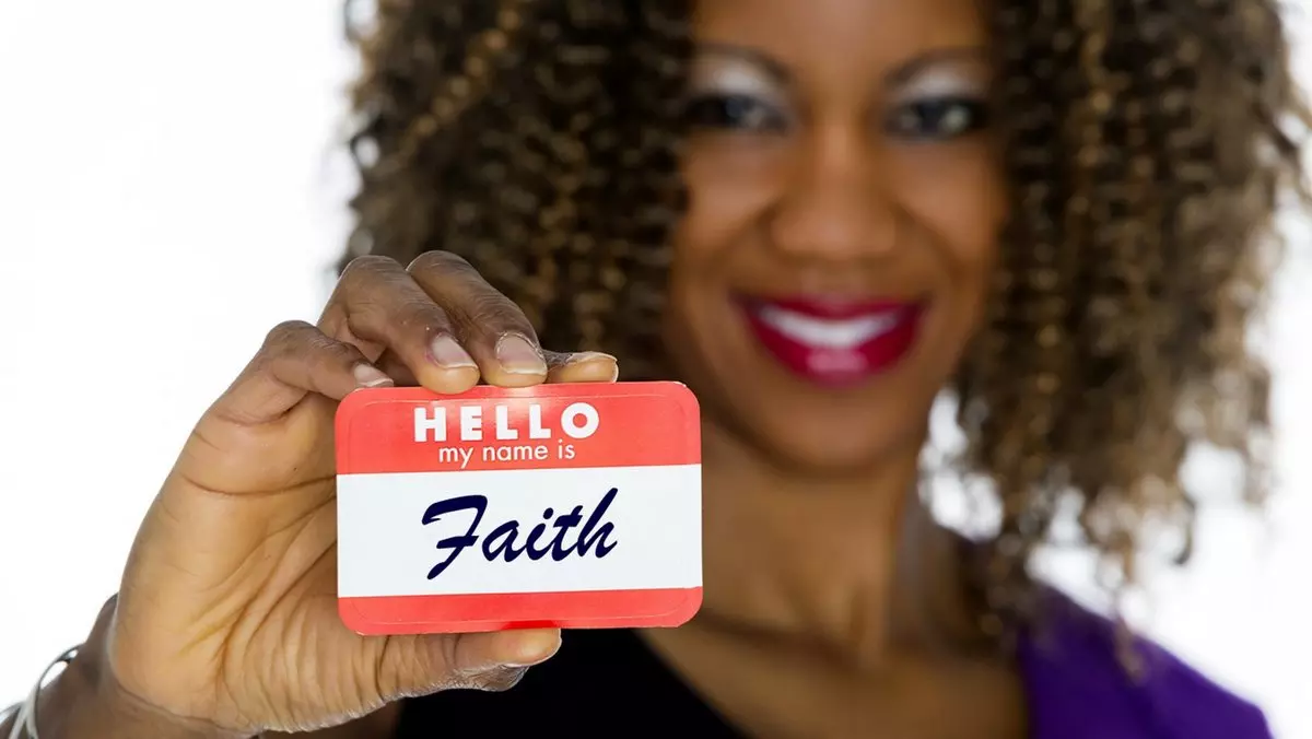 FAITH HAS COME WE ARE NO LONGER UNDER THE LAW::WOMAN HOLDING NAMETAG © RichLegg | iStockPhoto.com