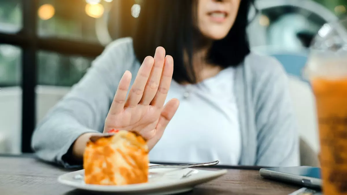 IT NO LONGER MATTERS WHAT WE EAT OR DRINK::WOMAN REFUSING CAKE © Piyapong Thongcharoen | Dreamstime.com