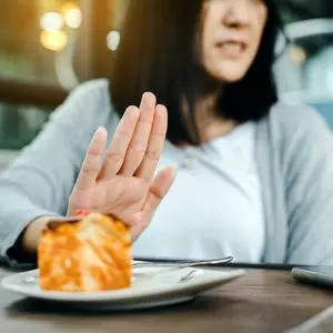 IT NO LONGER MATTERS WHAT WE EAT OR DRINK::WOMAN REFUSING CAKE © Piyapong Thongcharoen | Dreamstime.com