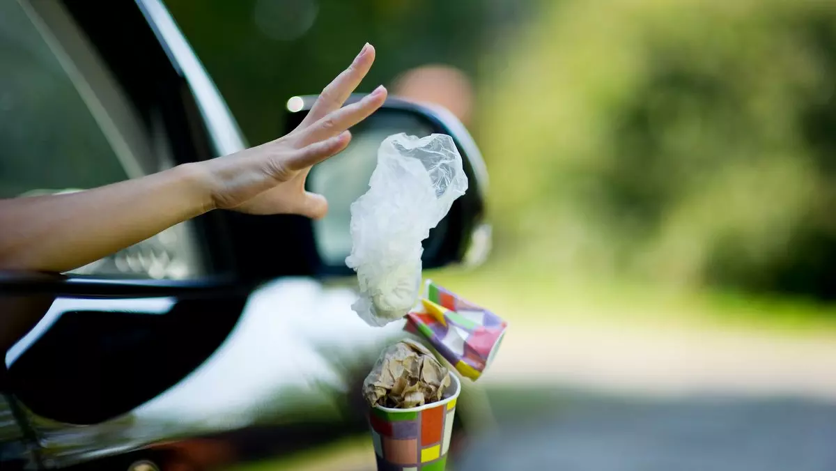 JESUS OBSERVED THE LAW SO WE DON'T HAVE TO::YOUNG WOMAN THROWS WASTE FROM THE CAR © Slava Dumchev | Shutterstock.com