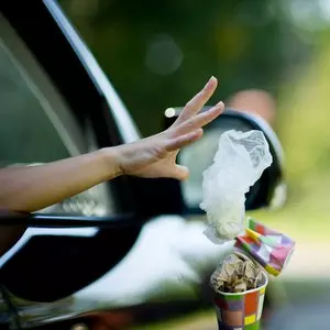 JESUS OBSERVED THE LAW SO WE DON'T HAVE TO::YOUNG WOMAN THROWS WASTE FROM THE CAR © Slava Dumchev | Shutterstock.com