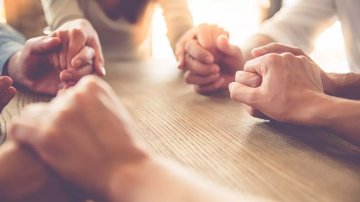 THE PHYSICAL LAW WAS GIVEN TO PHYSICAL ISRAEL::BUSINESS TEAM HOLDING HANDS AND PRAYING © vadimguzhva | iStockPhoto.com