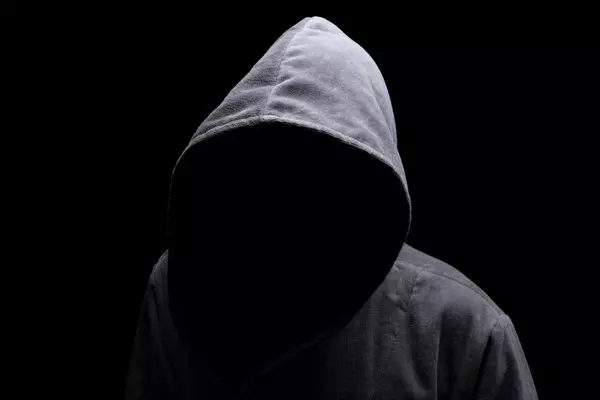MENACING SILHOUETTE OF HOODEN MAN IN THE SHADOW © Brian A Jackson | Shutterstock.com