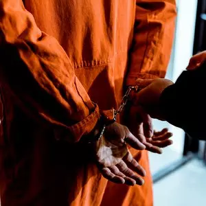 BEING UNDER THE LAW::PRISONER WEARING HANDCUFFS © LightFieldStudios | iStockPhoto.com