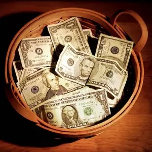 TITHING::BASKET OF MONEY © Suzanne Tucker | Dreamstime.com