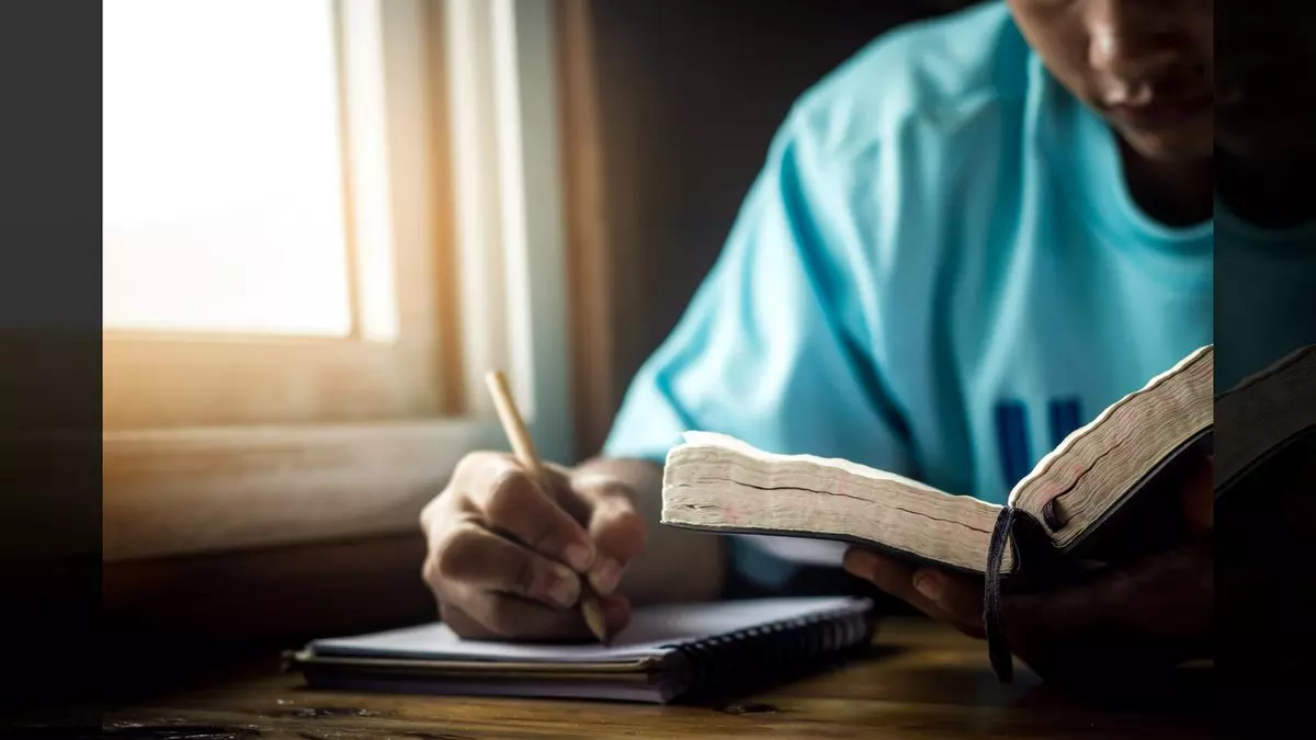 Lists in Scripture::YOUNG MAN READING THE BIBLE © Chat Karen Studio | Shutterstock.com