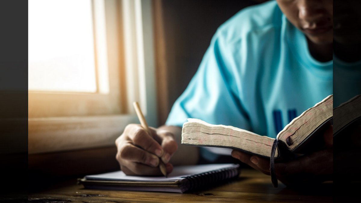 Lists in Scripture::YOUNG MAN READING THE BIBLE © Chat Karen Studio | Shutterstock.com